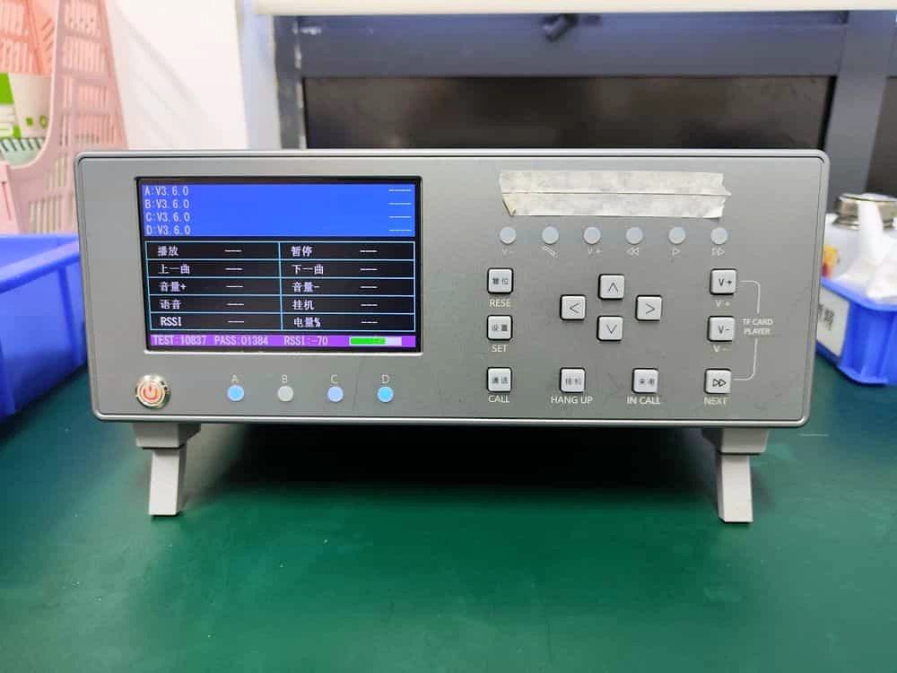 Bluetooth multifunction tester on a workbench in Alova's quality-control laboratory.
