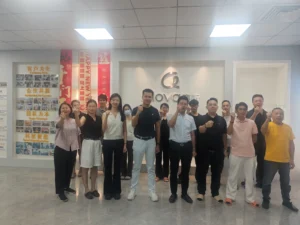 Alova team group photograph at the company brand wall